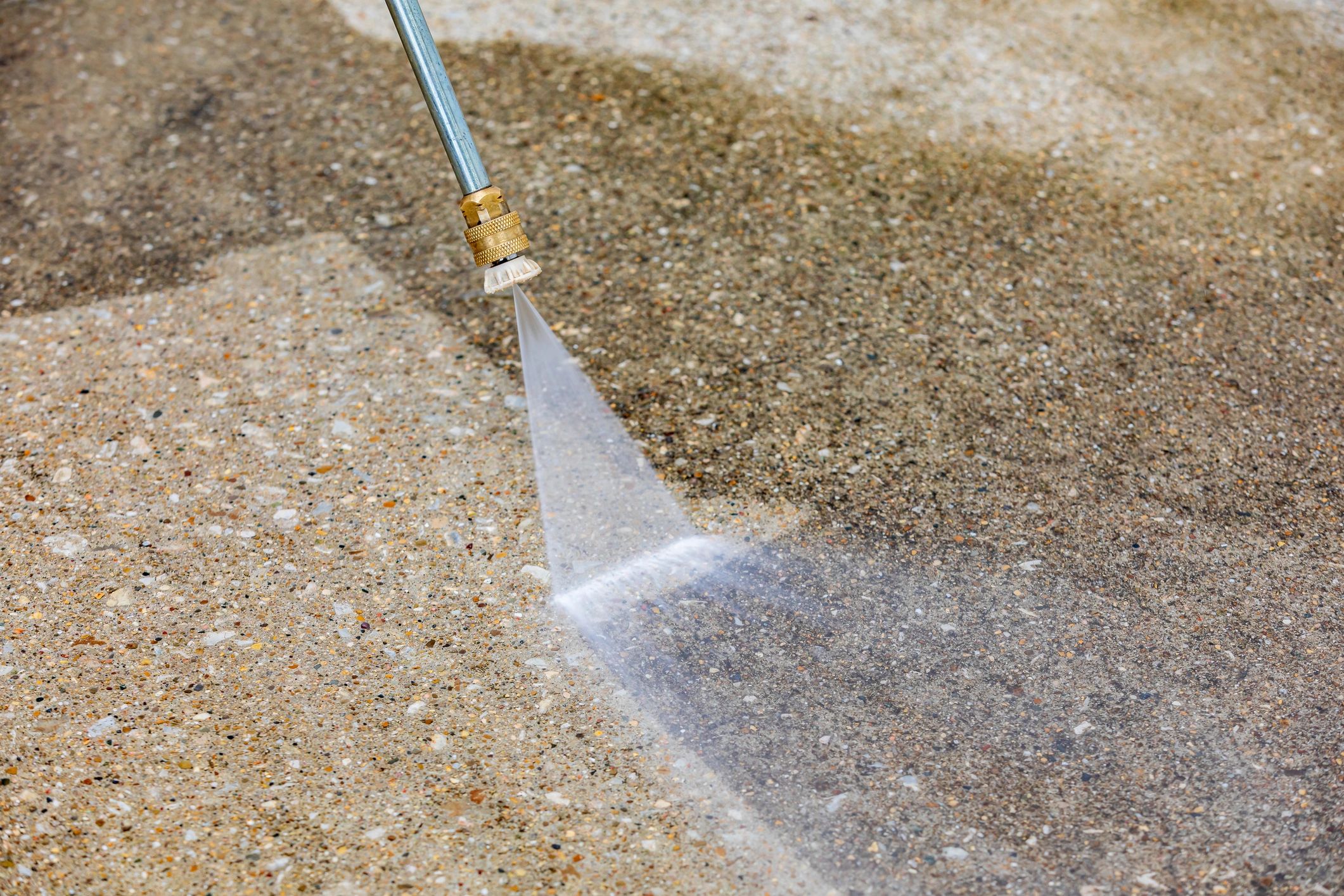 Pressure washing a concrete driveway for a brighter, safer surface