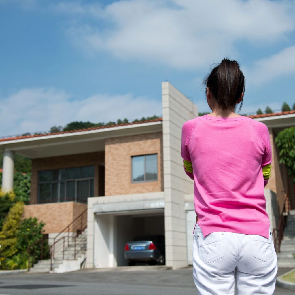 woman in front of new home